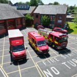Three fire vehicles in front of fire station taken from above