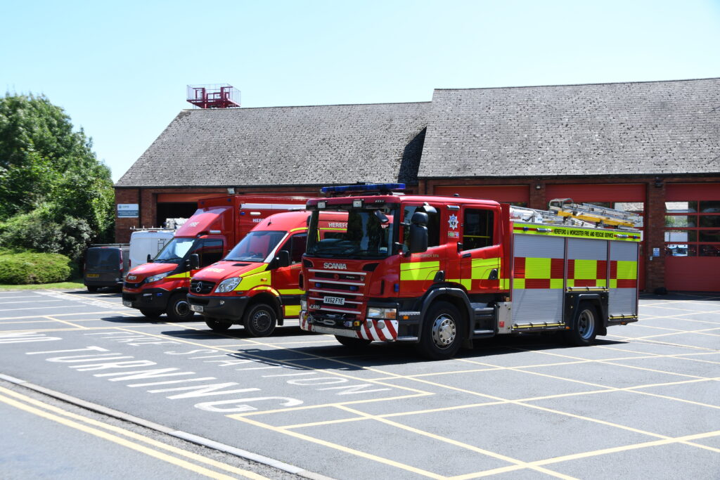 Three fire vehicles with fire engine in foreground