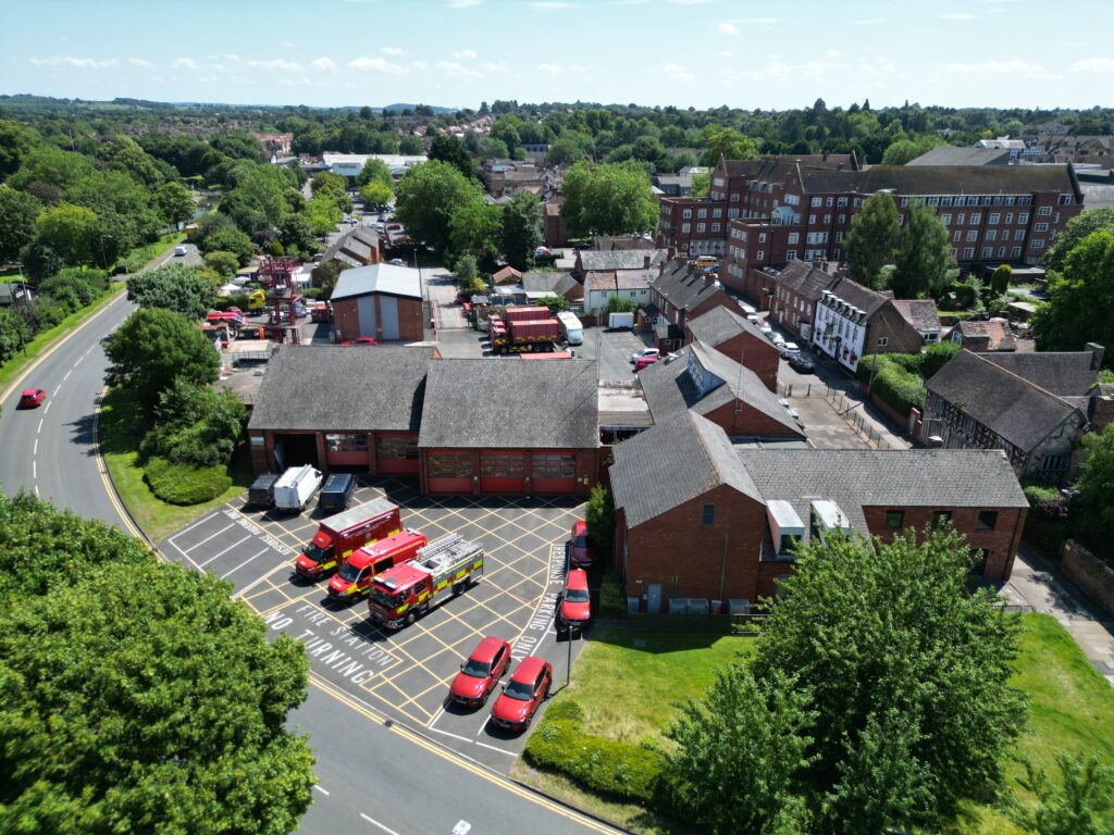 Drone shot of fire station with fire vehicles at front