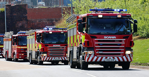 Three fire engines on blue lights