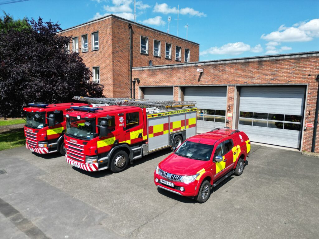 Three fire vehicles in front of fire station