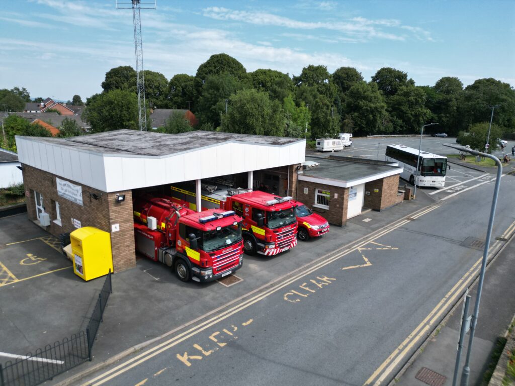 Fire station with three fire vehicles taken from above