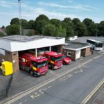 Fire station with three fire vehicles taken from above