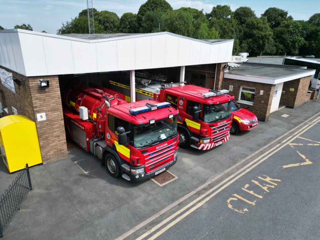 Fire station with three fire vehicles in front taken from above