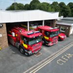 Fire station with three fire vehicles in front taken from above