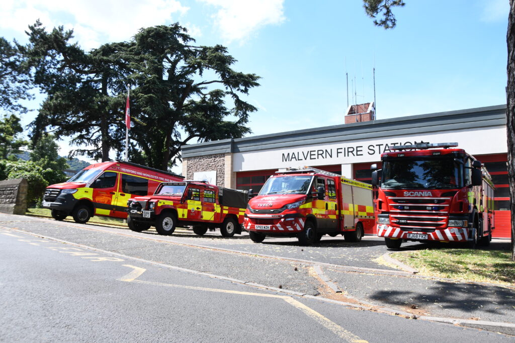Line up of fire vehicles with fire engine in foreground