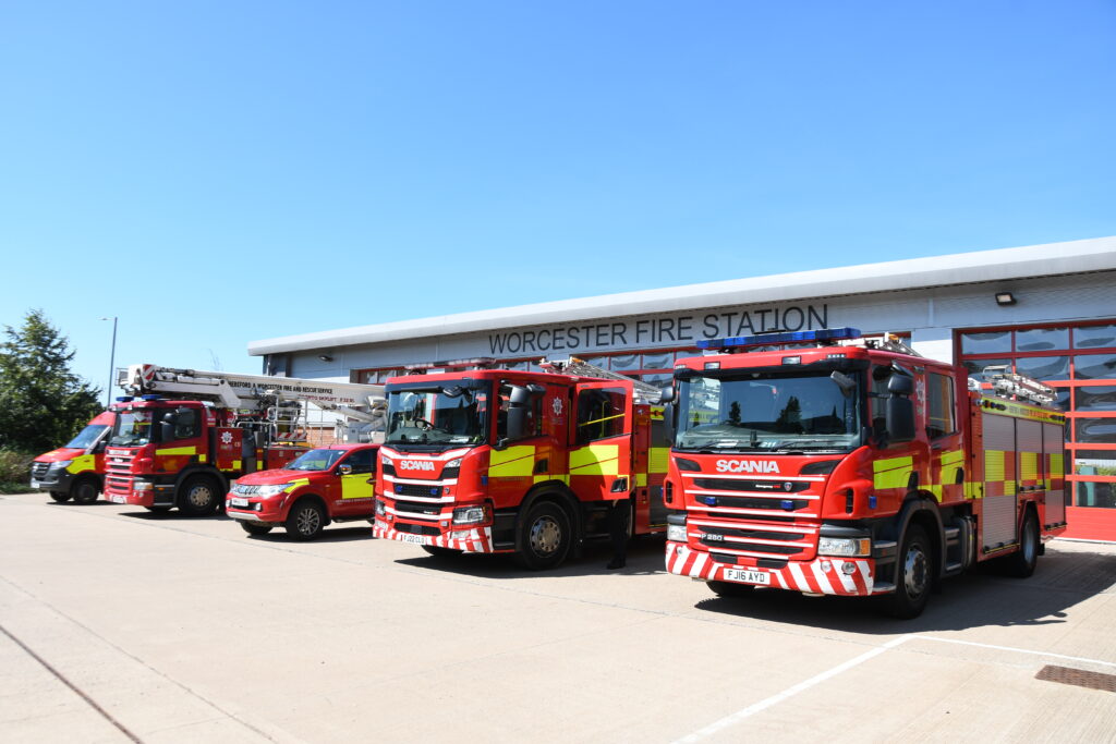 Line up of fire vehicles with fire engine in foreground