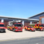 Line up of fire vehicles in front of fire station