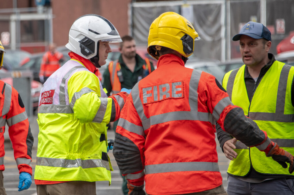 Crew and Watch Commanders talking to a person at a training inccident.